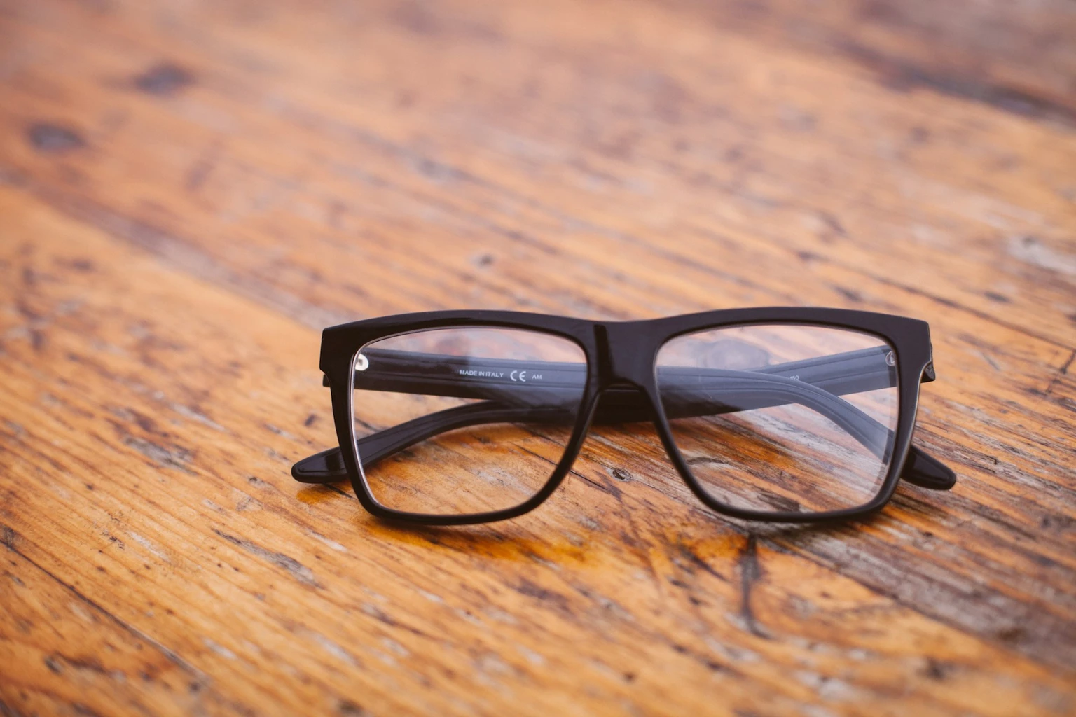 Spectacle frames on a wooden counter at AS Optics